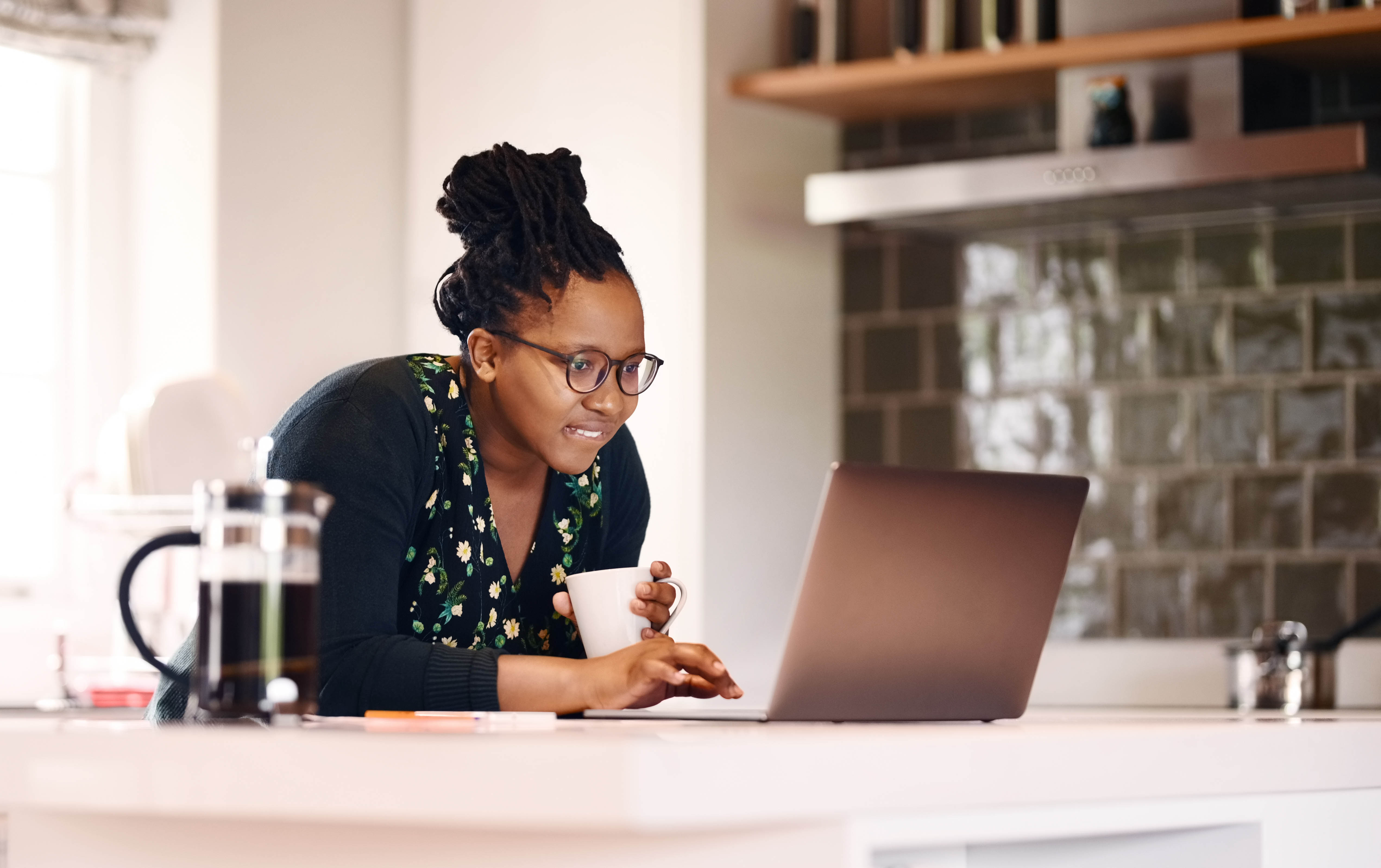 A young woman does research on her prescription medication using her laptop computer.