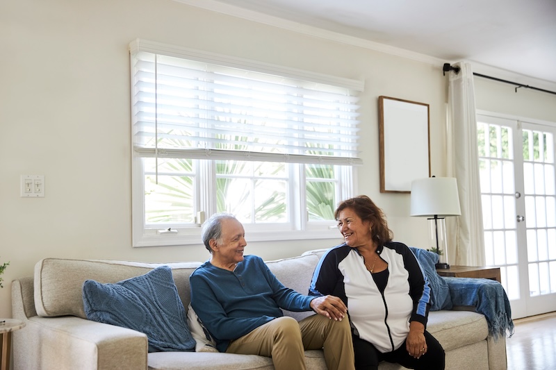 A couple sits on a couch